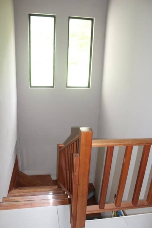 Interior staircase with wooden handrail in a new Ecuador property.
