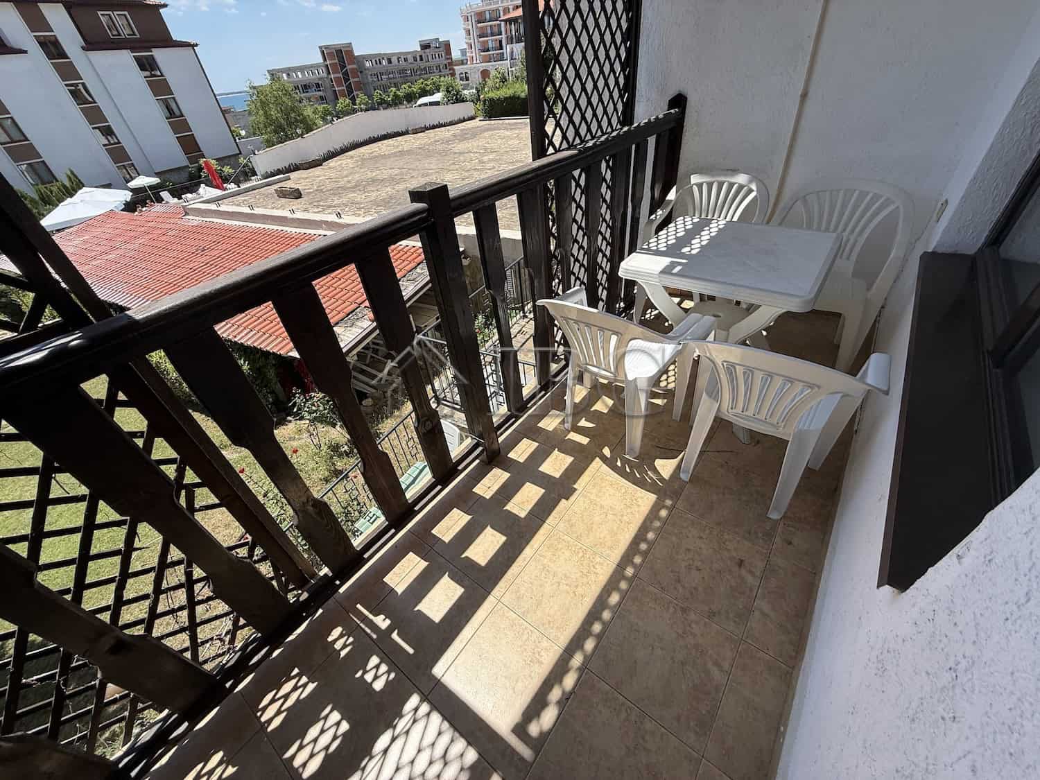 Balcony of a 2-bedroom apartment at Vodenitsata Complex, Sveti Vlas, offering outdoor space and city.