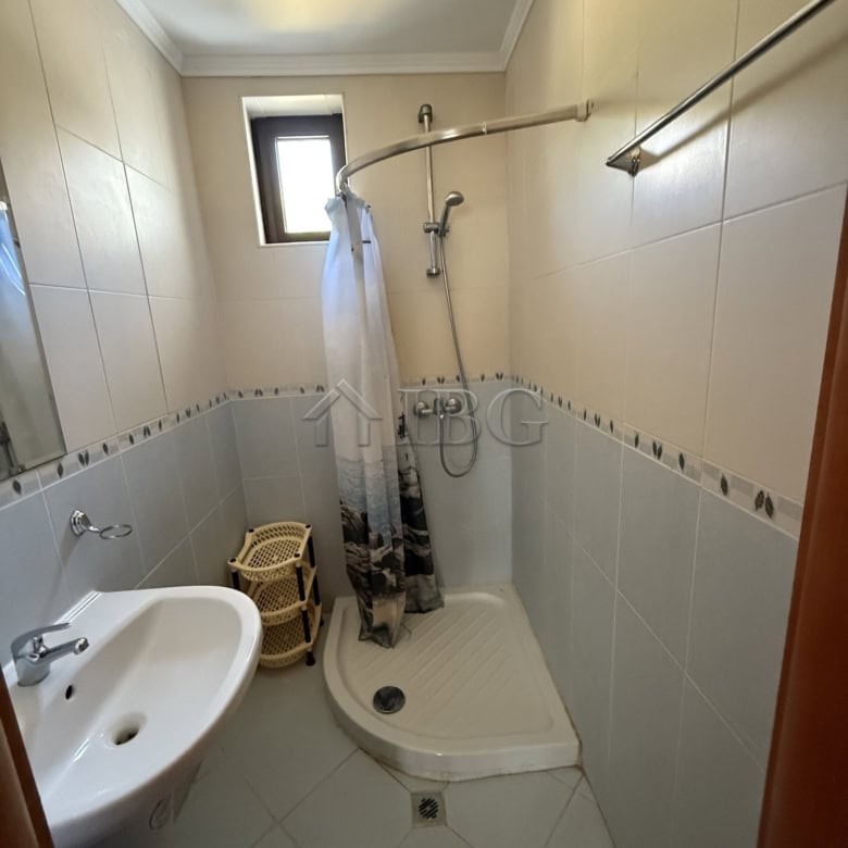 Compact bathroom with shower, sink, and small window in Vodenitsata Complex, Sveti Vlas.