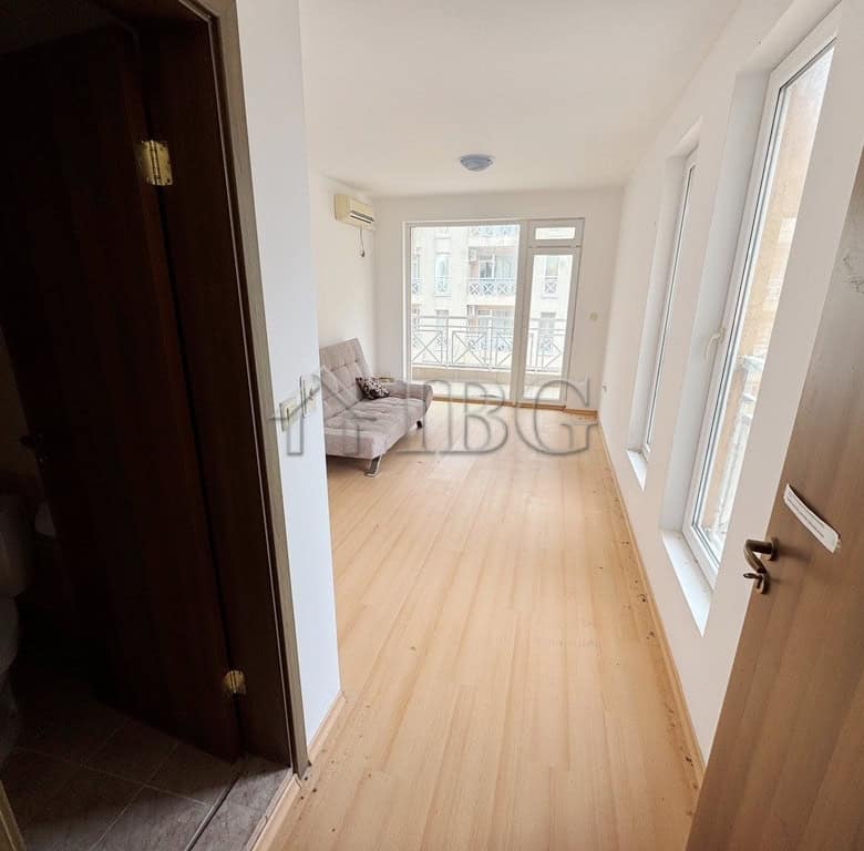 Bright studio apartment with balcony overlooking the pool area.