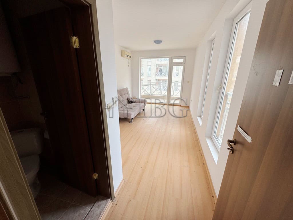 Bright studio apartment with balcony overlooking the pool area.