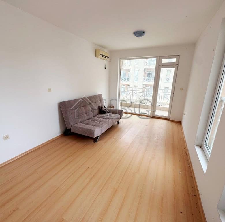 Cozy studio apartment with balcony overlooking the pool, perfect for sunny beach holidays.