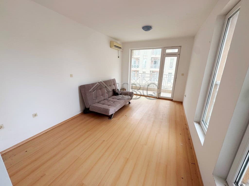 Cozy studio apartment with balcony overlooking the pool, perfect for sunny beach holidays.