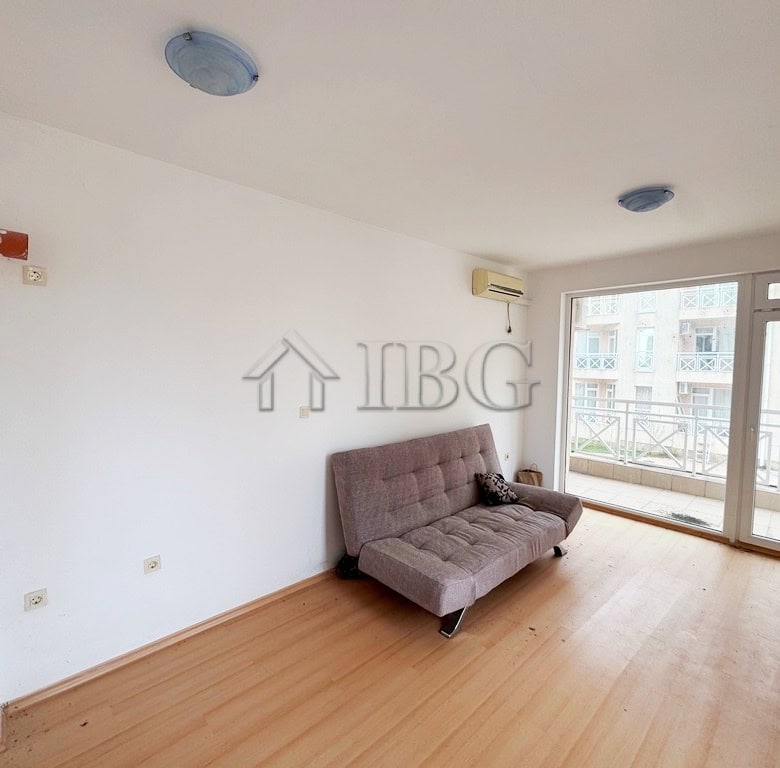 Studio apartment with balcony overlooking the pool area, perfect for sunny beach holidays.