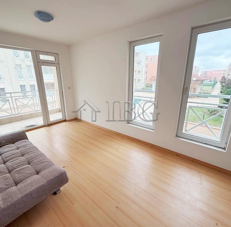 Bright studio apartment with balcony overlooking the pool, perfect for sunny beach holidays.