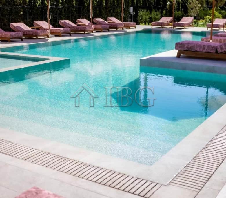 Swimming pool with lounge chairs at J’adore Secret Garden residential complex in Sunny Beach.