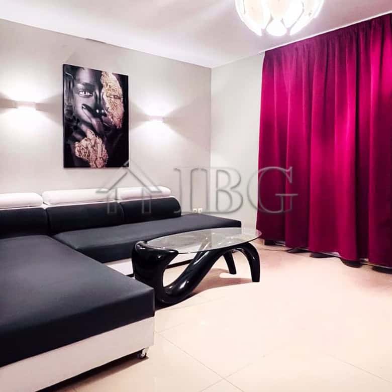 Elegant living room with modern furniture and vibrant pink curtains.