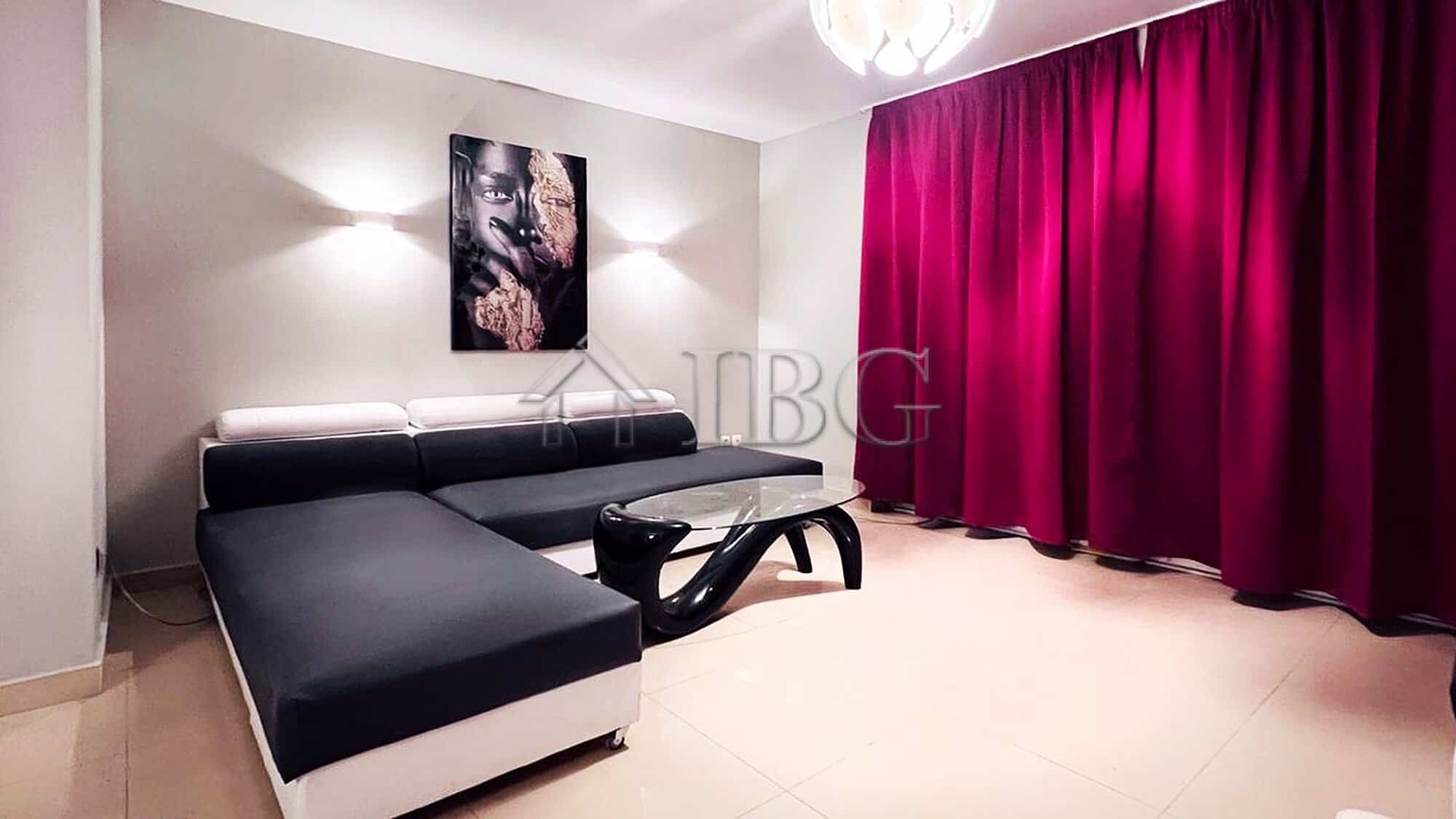 Elegant living room with modern furniture and vibrant pink curtains.