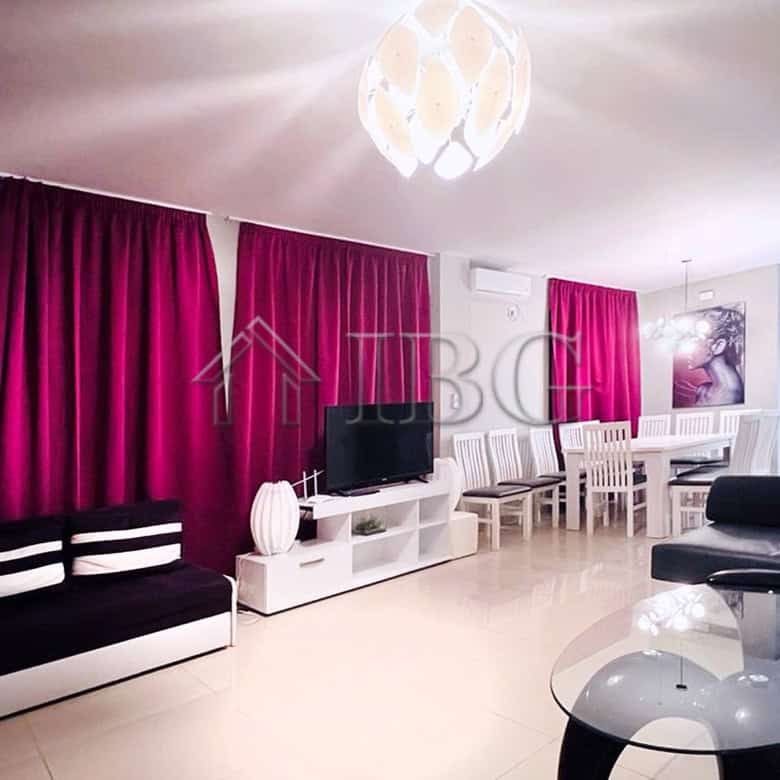 Elegant living room with vibrant pink curtains and modern furniture in Villa Sorrento.