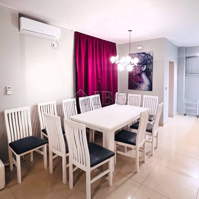 Elegant dining room in a luxury villa featuring a white table, stylish chairs, and contemporary ligh.