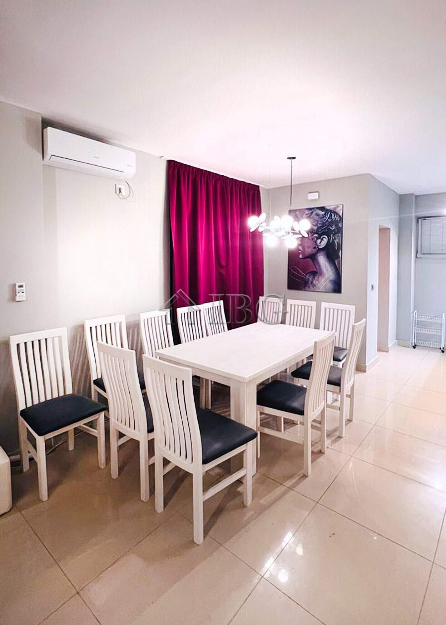 Elegant dining room in a luxury villa featuring a white table, stylish chairs, and contemporary ligh.