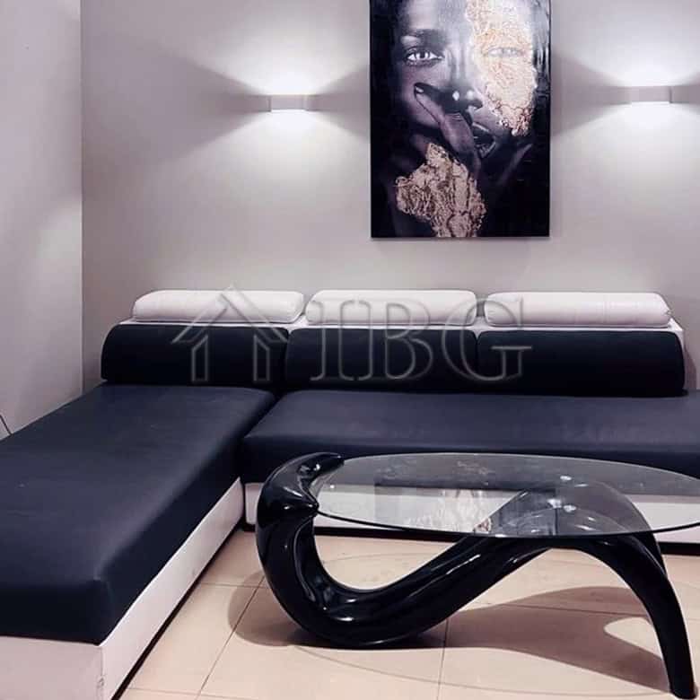 Stylish living space featuring black and white furniture, modern art, and ambient lighting for a lux.