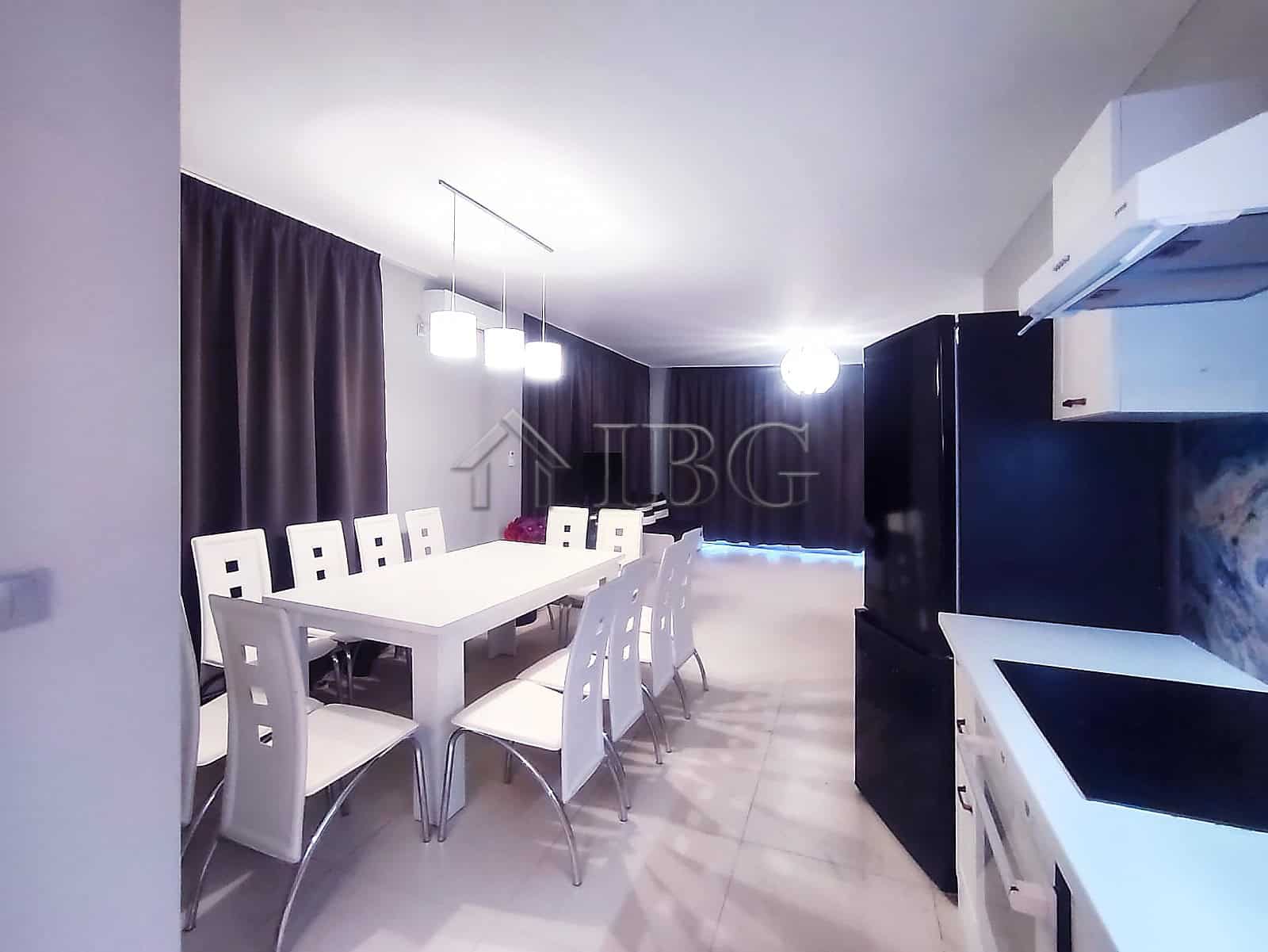 Elegant sea view dining room with modern furniture and ambient lighting.