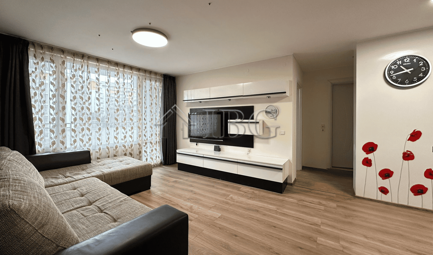 Bright living room with large windows and marina scenery in Sveti Vlas. Modern furnishings and cozy.