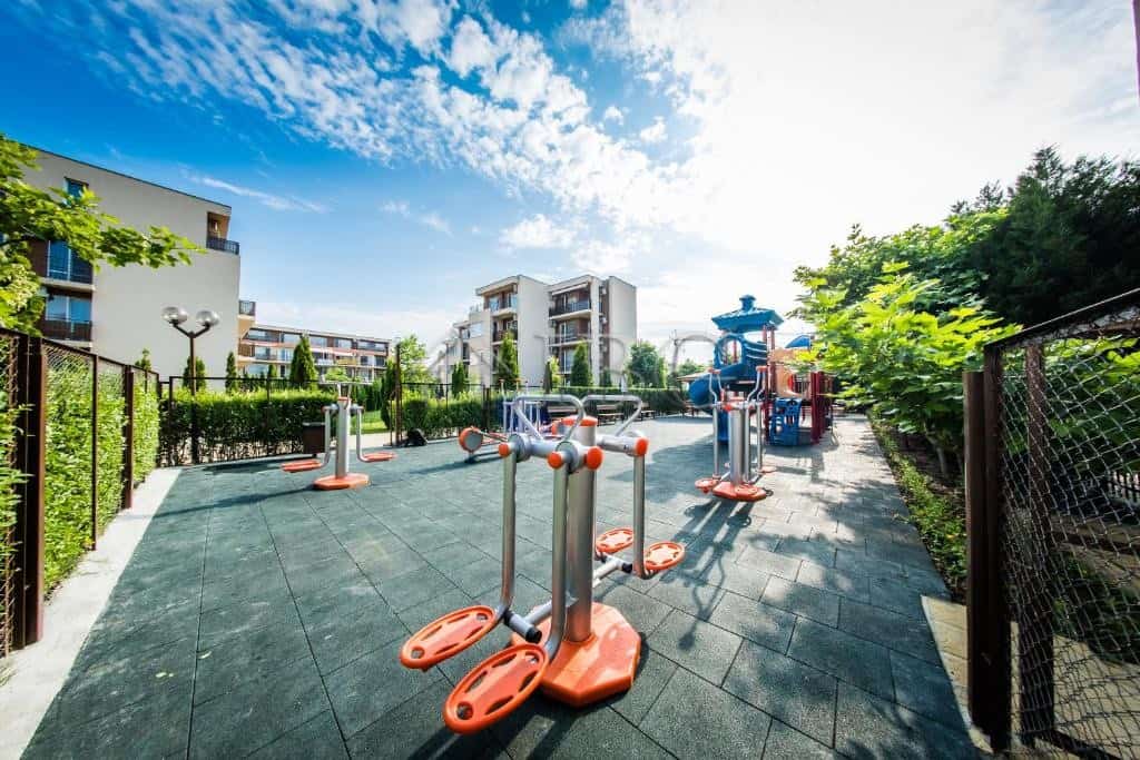 Outdoor gym equipment in a sunny, landscaped setting at Nessebar Fort Club, Sunny Beach.