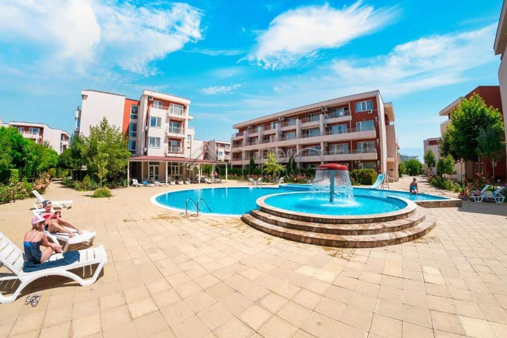 Pool view of a 1-bedroom apartment at Nessebar Fort Club, Sunny Beach, with a large swimming pool an.