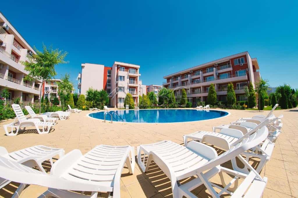 Pool view of a 1-bedroom apartment at Nessebar Fort Club, Sunny Beach, with a large swimming pool an.