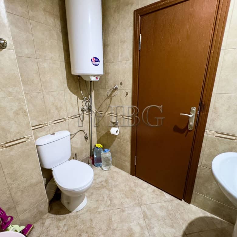 Bathroom with toilet, water heater, and sink in Sveti Vlas studio.