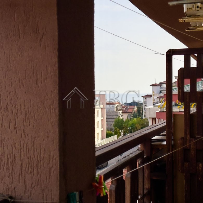 Bright balcony view of Sveti Vlas with city buildings and greenery.