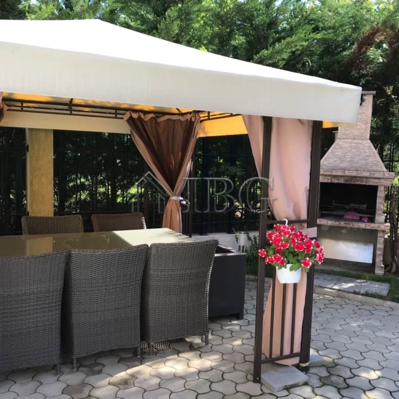 Outdoor lounge with seating and garden view at Pomorie Residence, Bulgaria.
