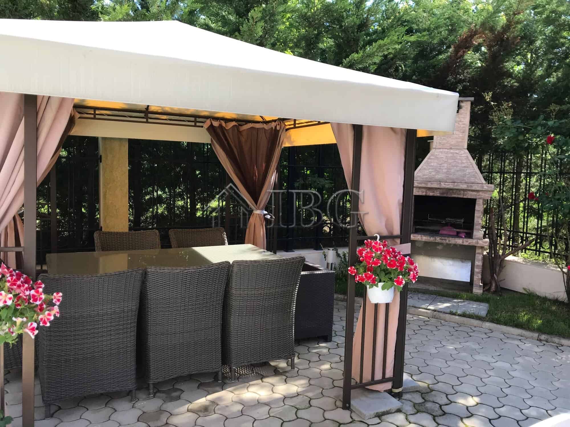 Outdoor lounge with seating and garden view at Pomorie Residence, Bulgaria.