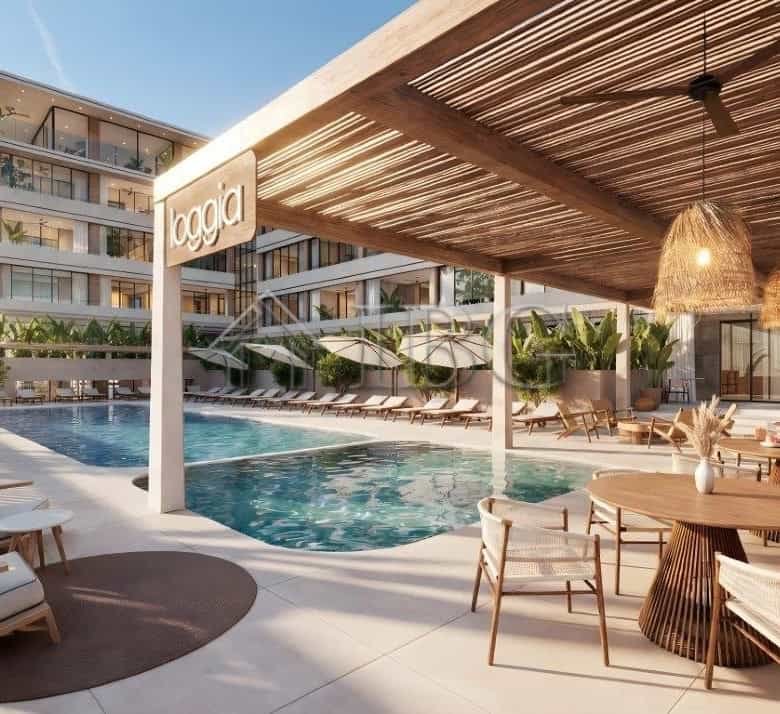 Luxurious loggia residences near the sea with pool and outdoor lounge area.