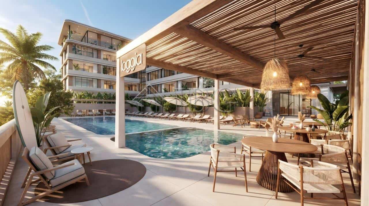 Luxurious loggia residences near the sea with pool and outdoor lounge area.