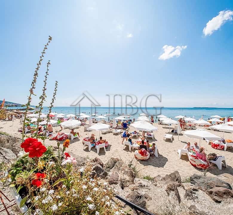 Beautiful beach scene with sun loungers and umbrellas at Premier Fort Beach, Sveti Vlas.