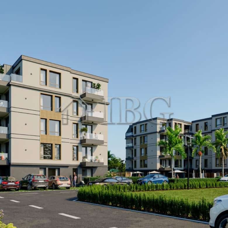 Contemporary apartment buildings in Ravda with balconies and lush surroundings.