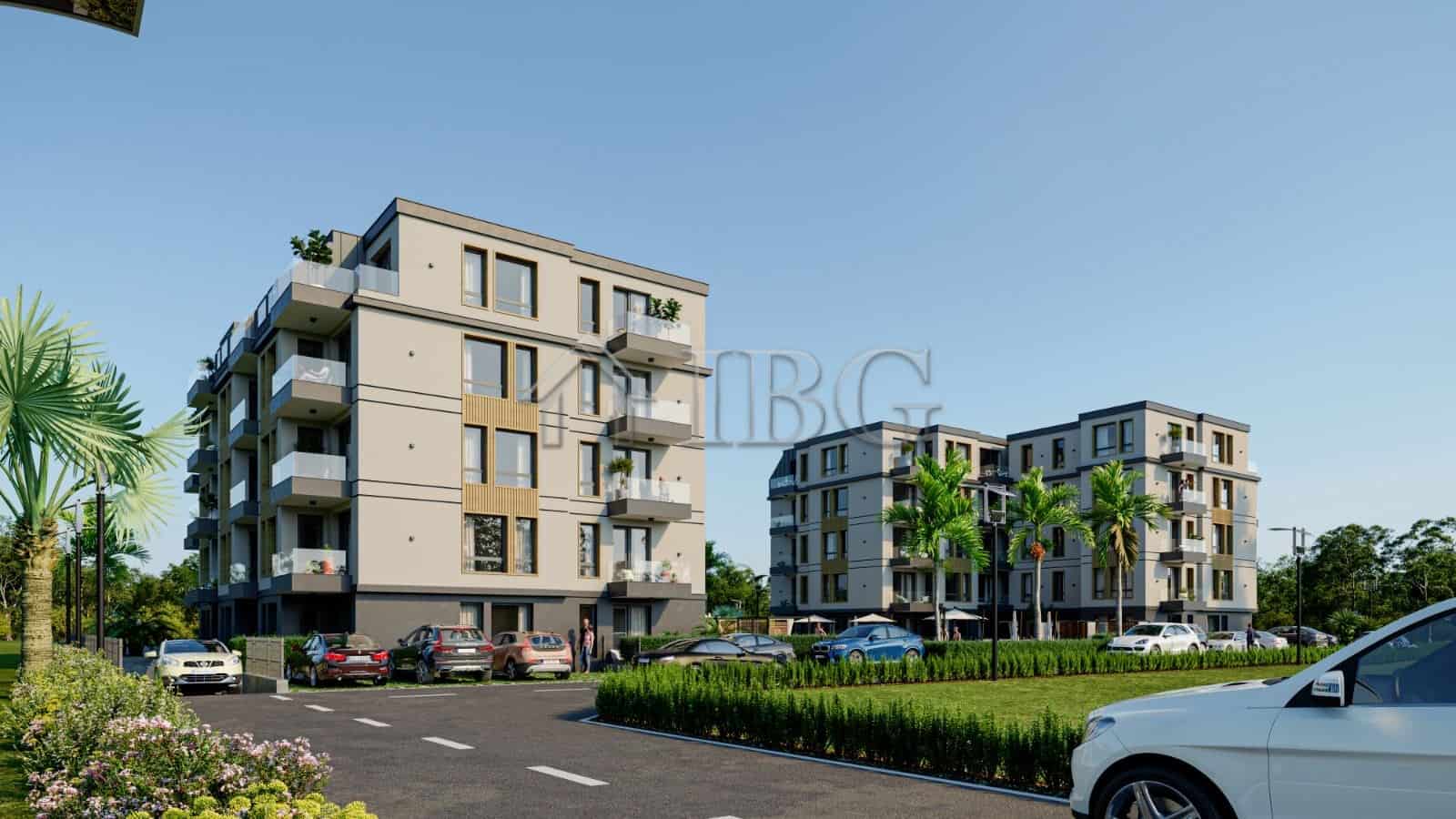 Contemporary apartment buildings in Ravda with balconies and lush surroundings.