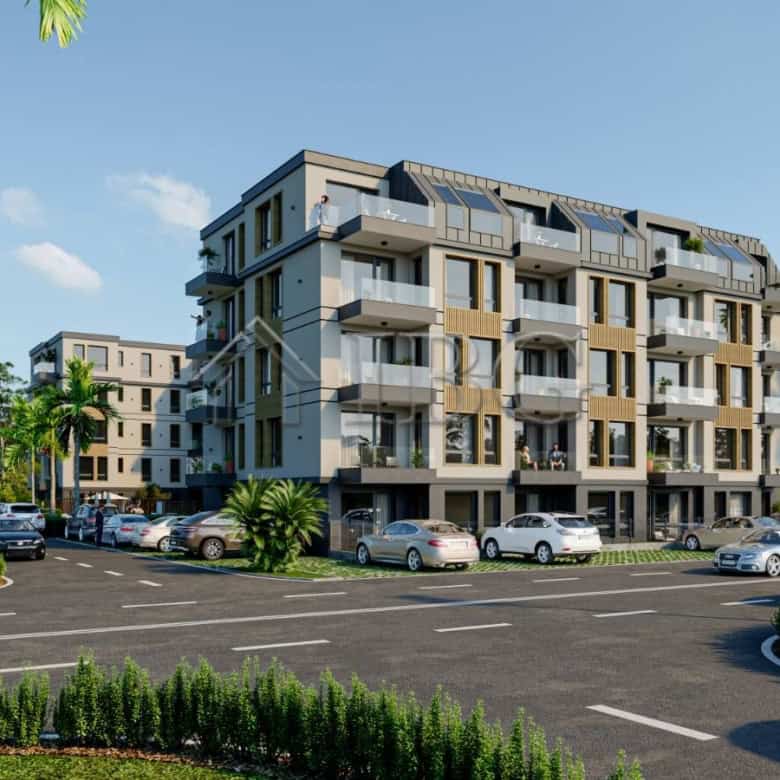 Modern apartment building in Ravda with balconies and lush surroundings.