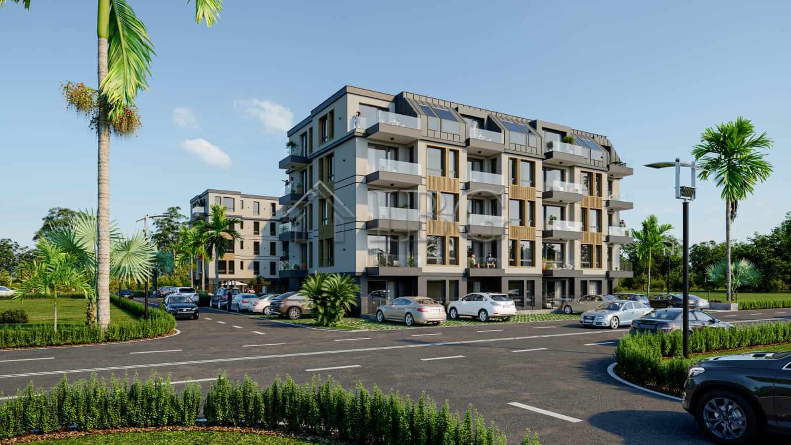 Modern apartment building in Ravda with balconies and lush surroundings.