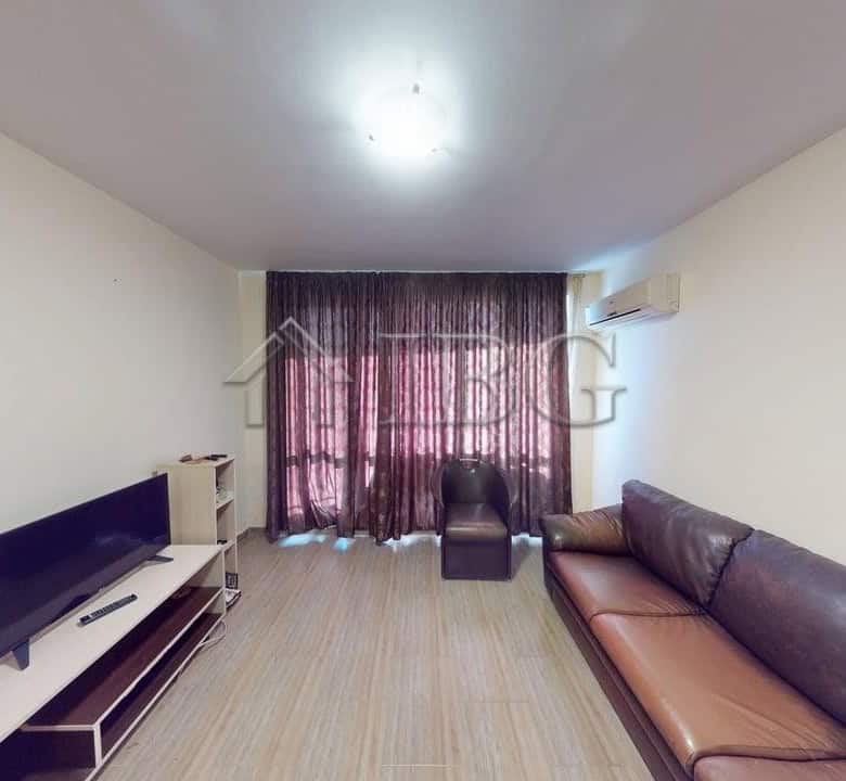 Modern one-bedroom apartment with living room and large window in Rio.