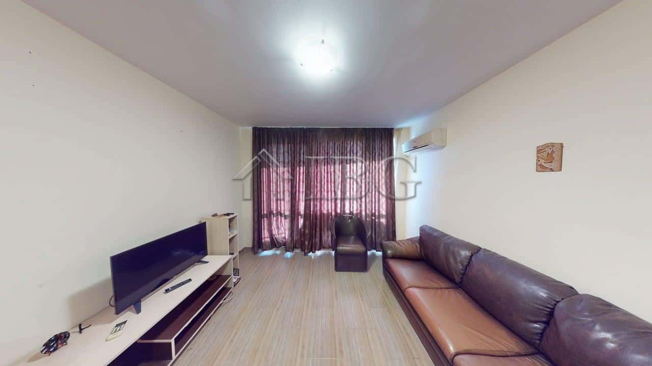 Modern one-bedroom apartment with living room and large window in Rio.