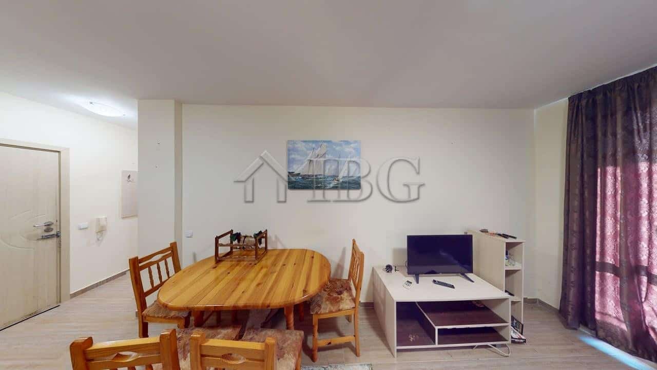 Bright one-bedroom apartment with modern furnishings and a dining area.