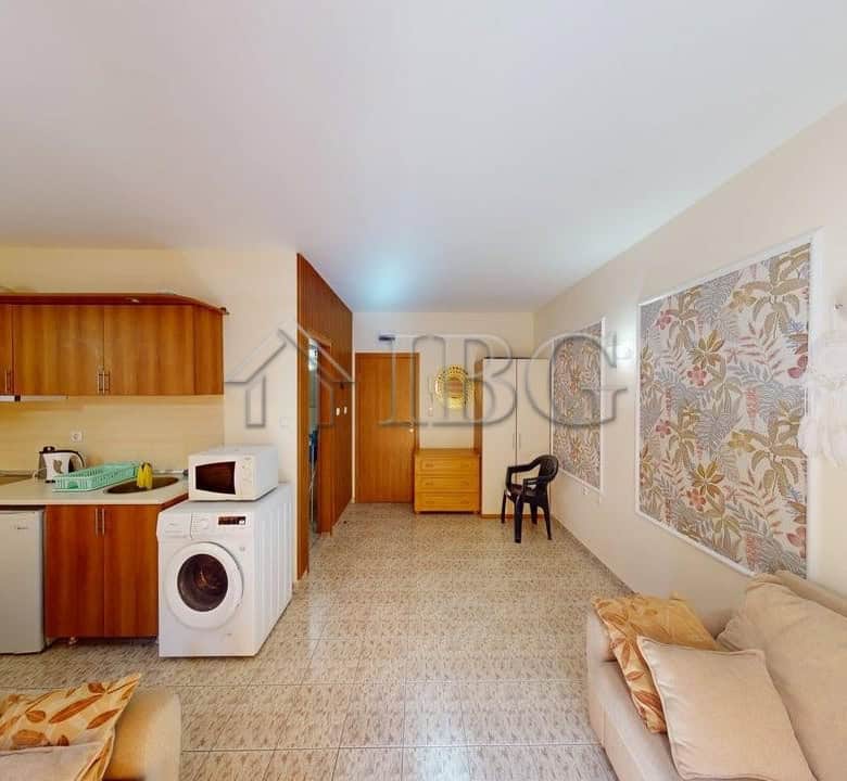 Cozy studio apartment with balcony overlooking lush green yard in Royal Dreams complex, Sunny Beach.