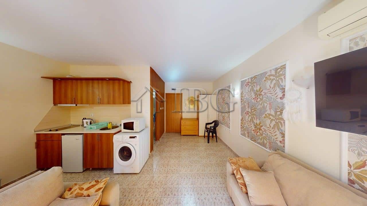 Cozy studio apartment with balcony overlooking lush green yard in Royal Dreams complex, Sunny Beach.