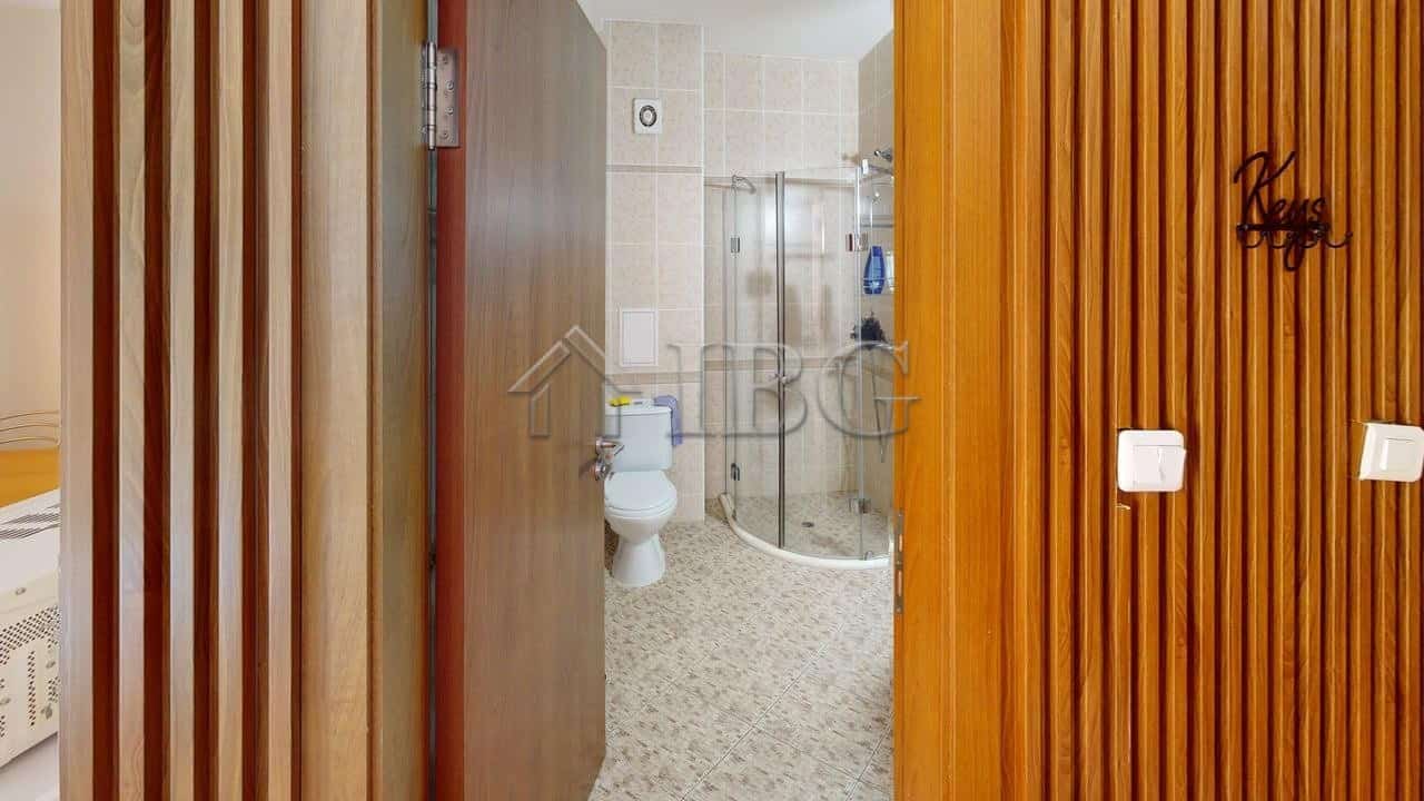 Interior view of a studio apartment with balcony and access to green yard in Royal Dreams, Sunny Bea.
