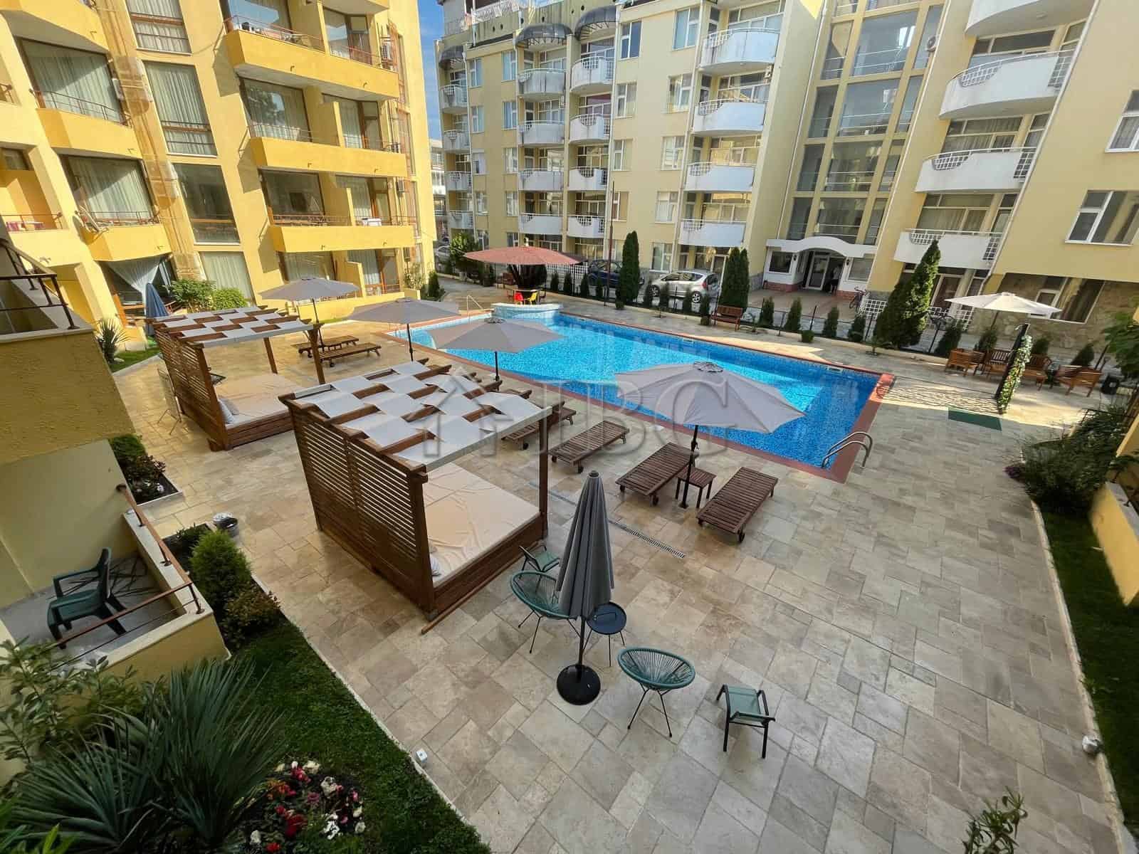 Spacious 2-bedroom apartment with pool, balconies, and outdoor lounge in Sands Complex, Sunny Beach.