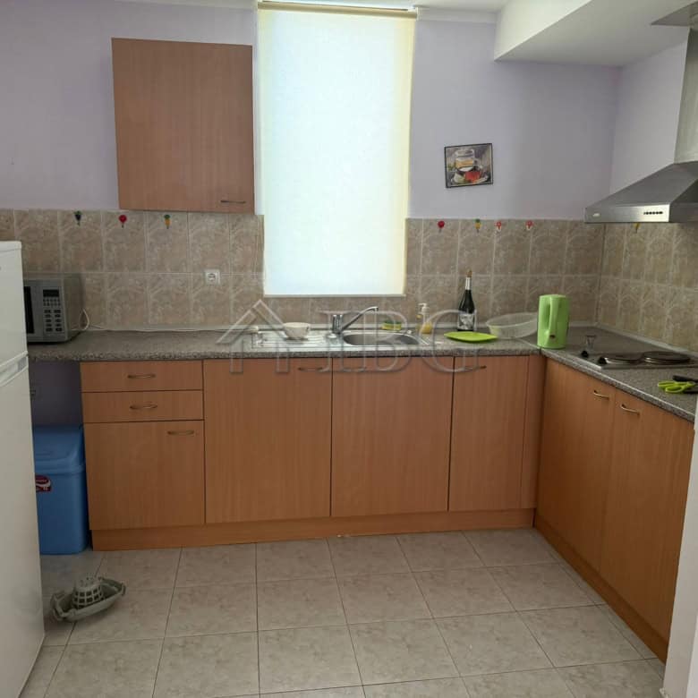 Bright kitchen with wooden cabinets and modern appliances in Sands Complex, Sunny Beach.