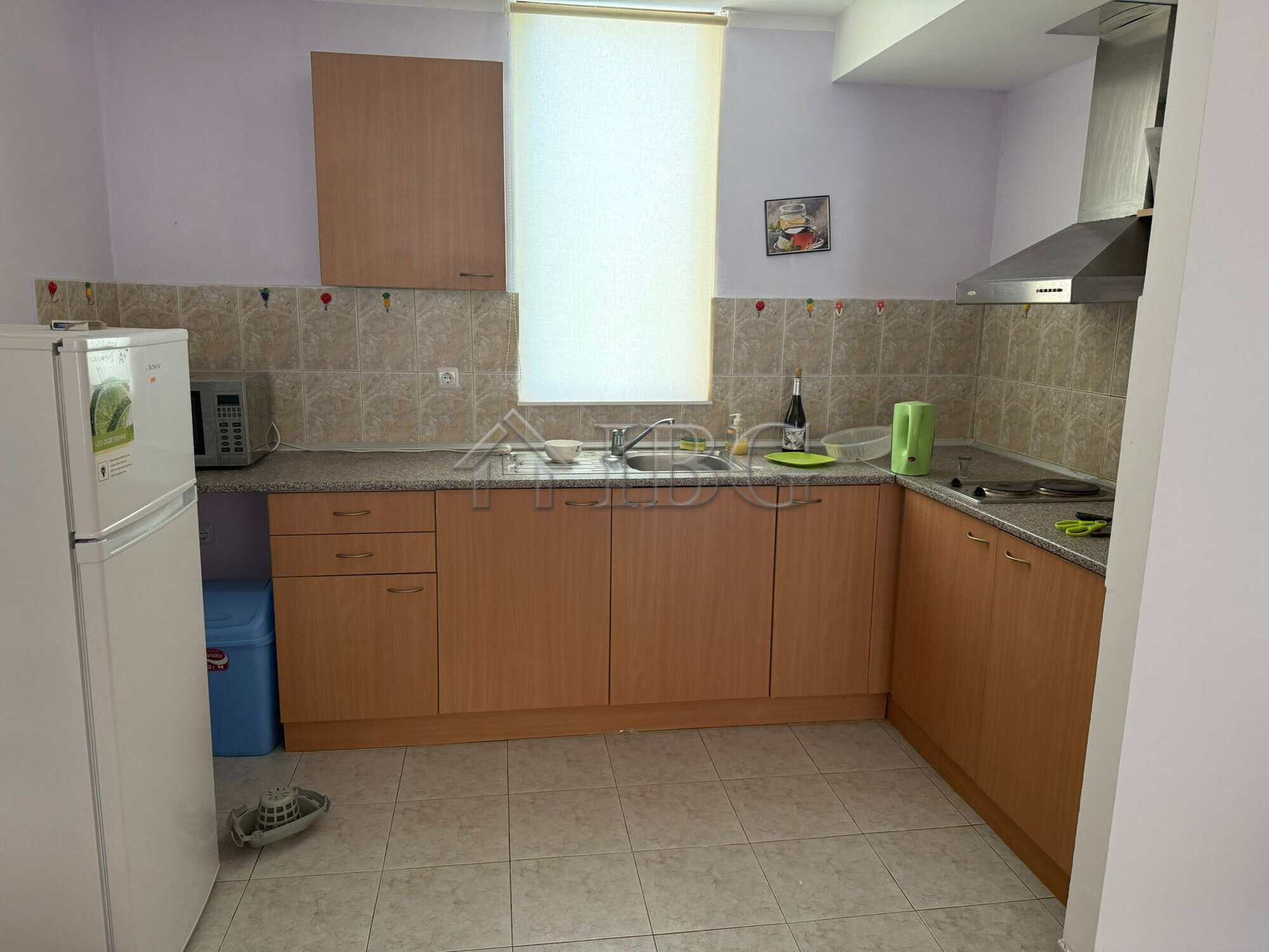Bright kitchen with wooden cabinets and modern appliances in Sands Complex, Sunny Beach.