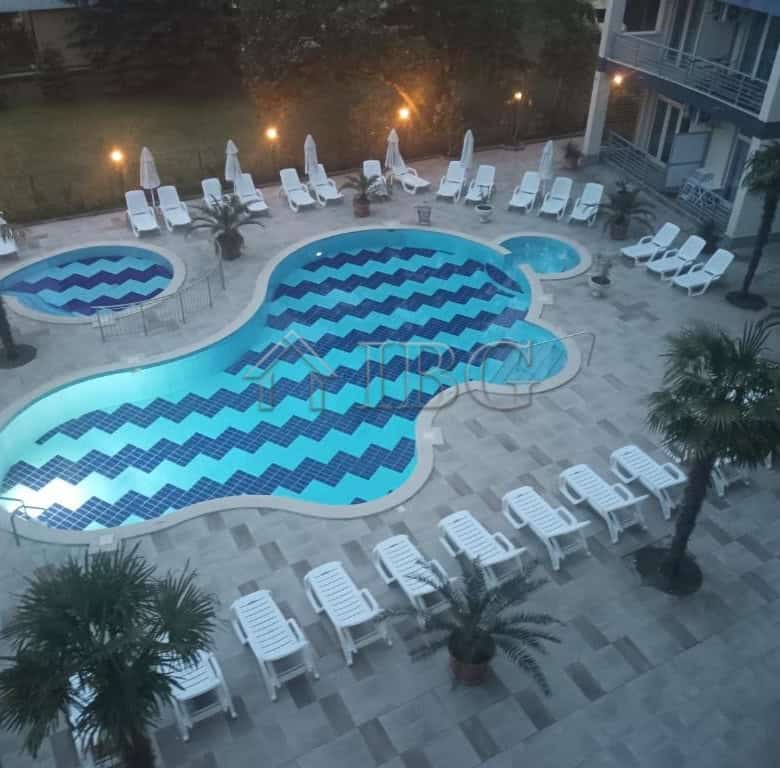 Pool with large terrace and lounge chairs at Sol e Mar, Sunny Beach.