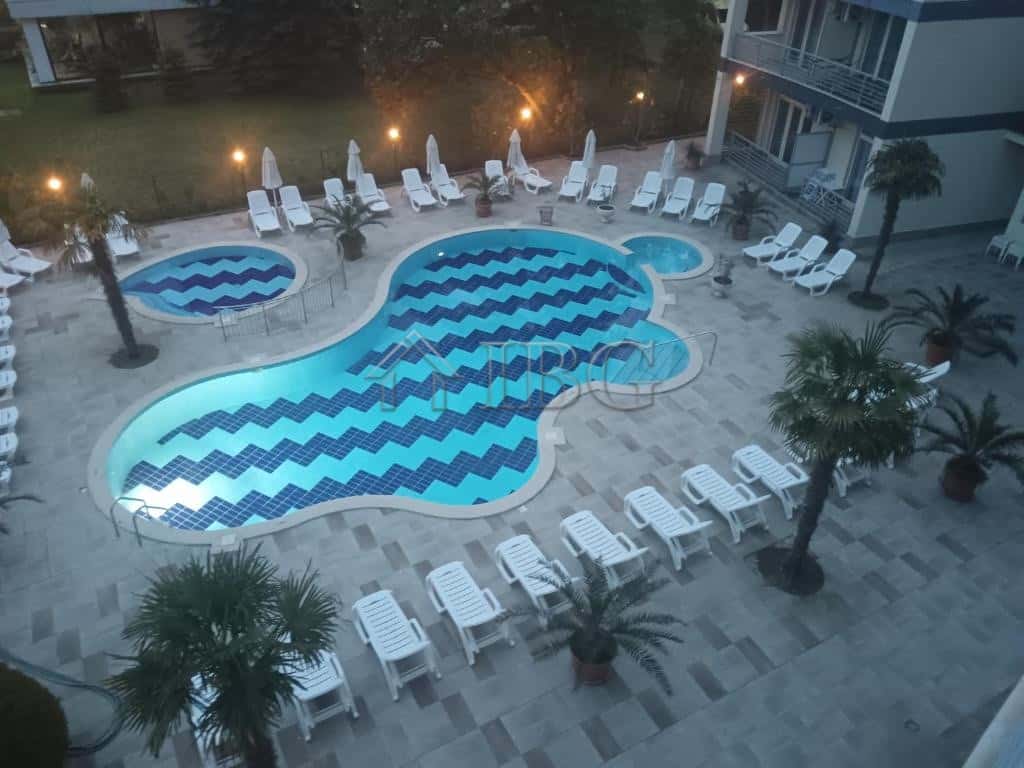 Pool with large terrace and lounge chairs at Sol e Mar, Sunny Beach.