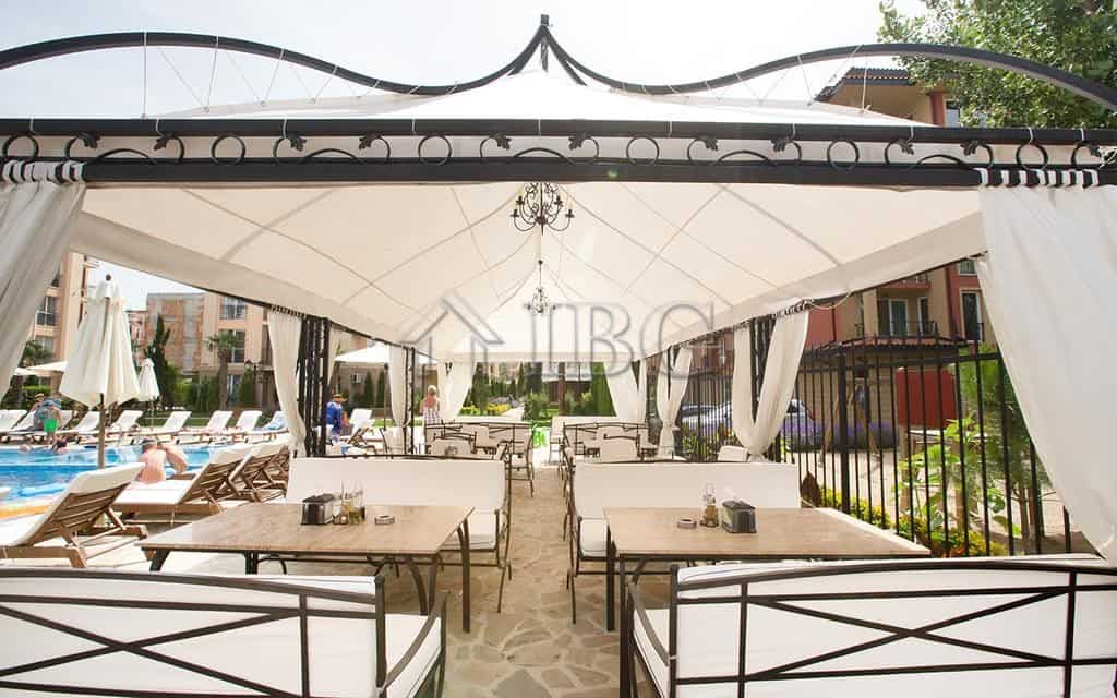 Outdoor lounge with sunbeds and shaded seating at Sunny Beach.