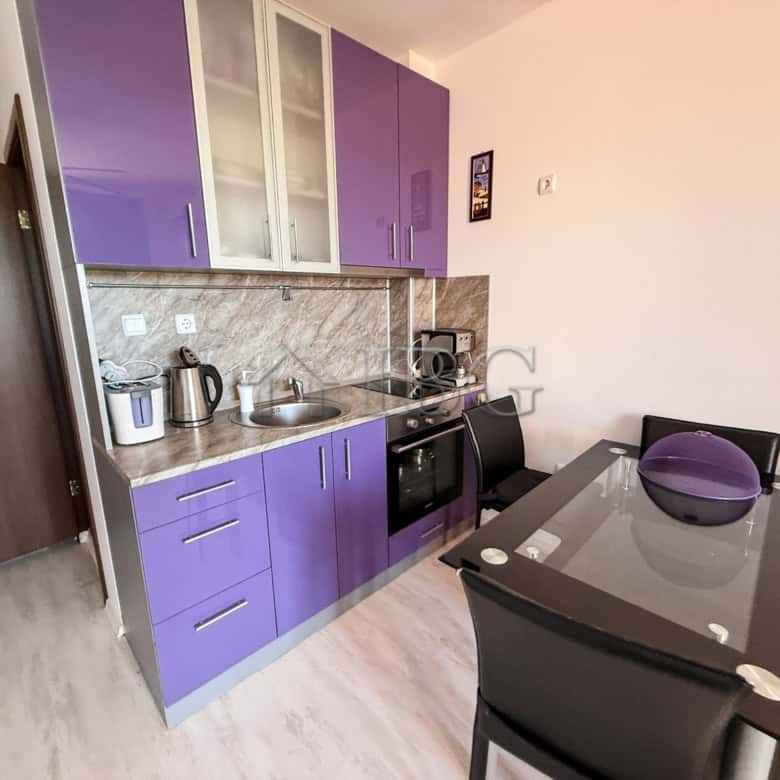 Furnished 2-room apartment with modern purple kitchen cabinets near Sunny Beach, Bulgaria. Perfect f.
