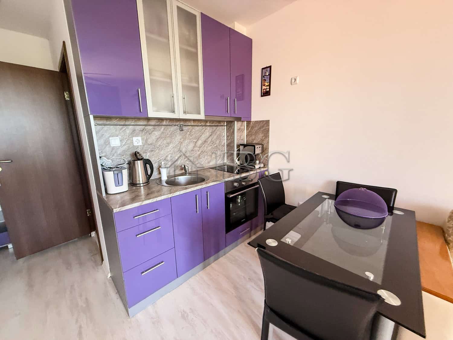 Furnished 2-room apartment with modern purple kitchen cabinets near Sunny Beach, Bulgaria. Perfect f.