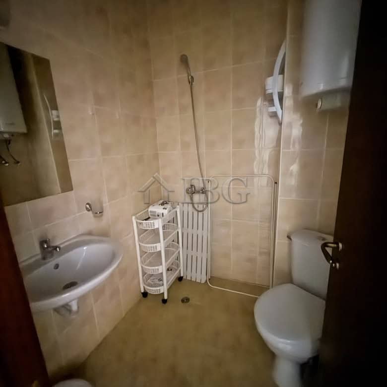 Furnished 2-room apartment bathroom with shower, toilet, and sink in a compact space.