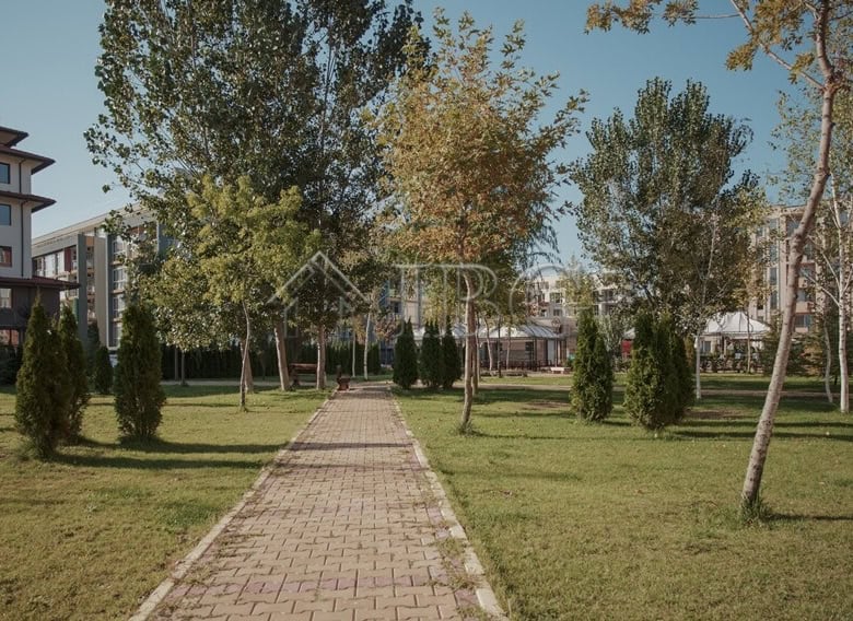 Modern residential complex with landscaped gardens and walking paths.