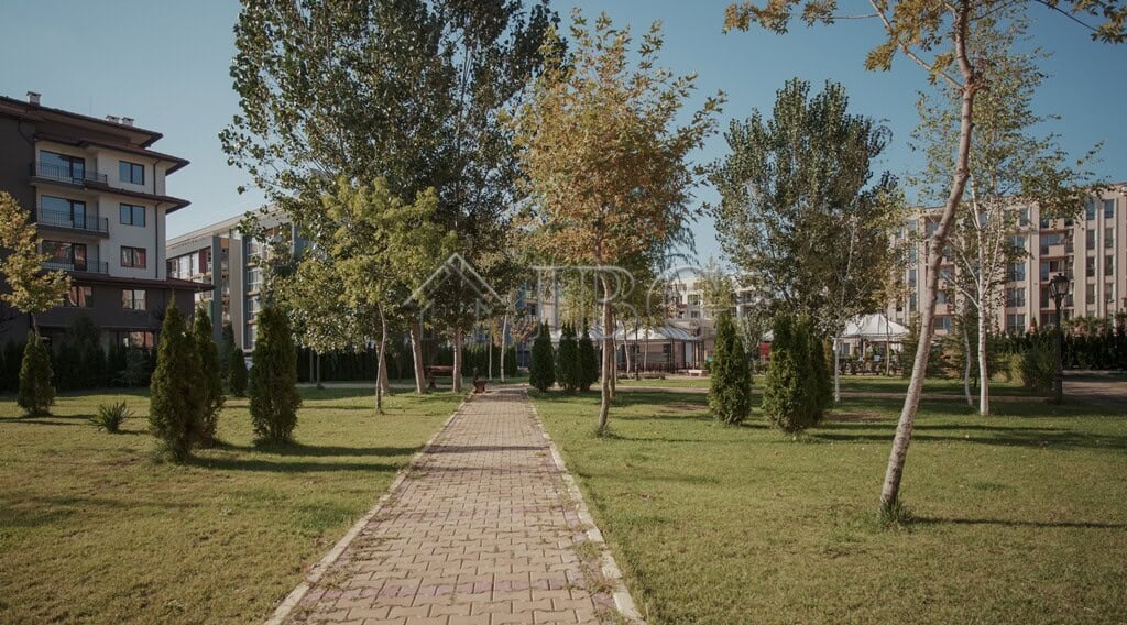 Modern residential complex with landscaped gardens and walking paths.