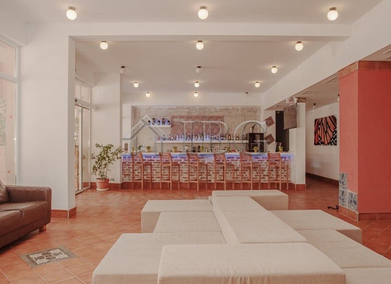 Modern lobby with comfortable seating and a reception desk in a new apartment building.